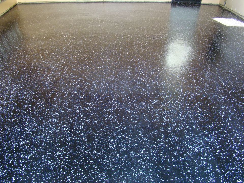 Completed dark flake polyaspartic garage floor