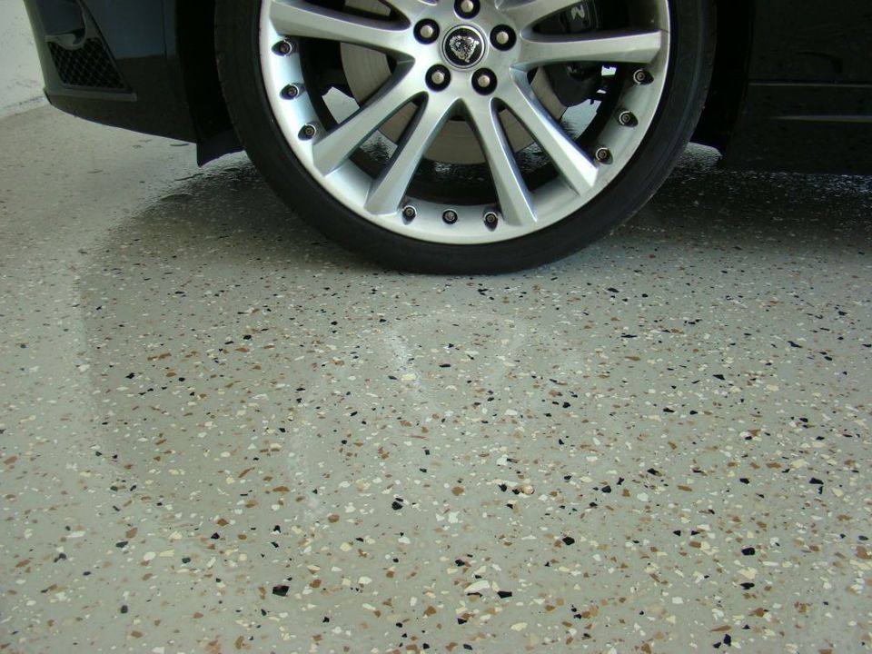 Completed polyaspartic garage floor with vehicle